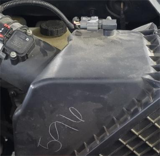 Unplug the grey connector on top of the filter housing
