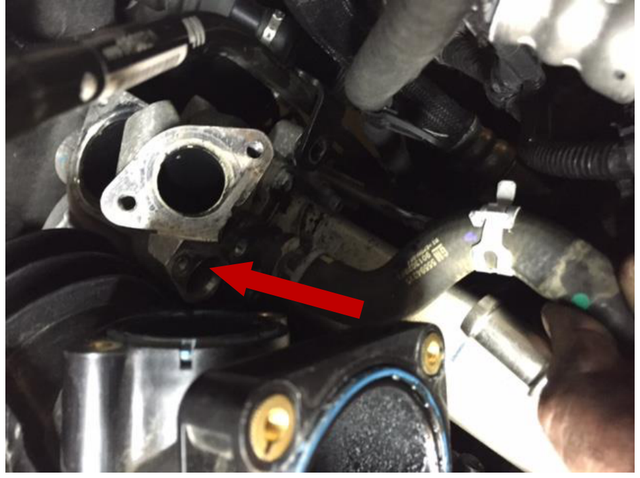 Remove the upper coolant hose barb from the EGR housing