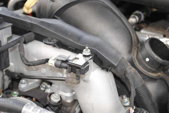 Mount the wiring harness back on top of the cast intake