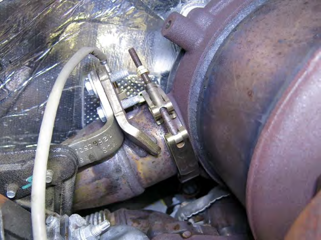 Loosen the two V-band clamps on the SCR