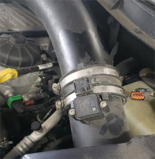 Loosen the 2 hose clamps at the back of the air filter housing