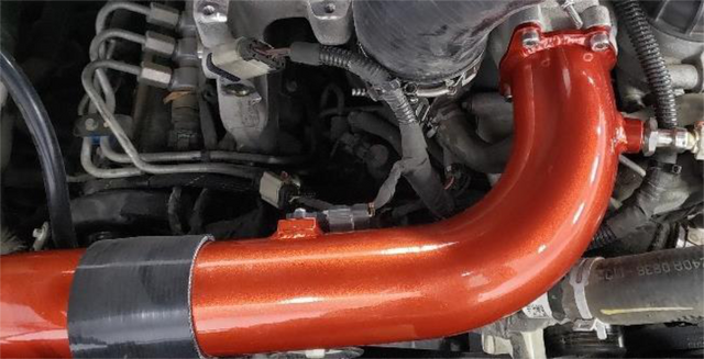 Bolt the charge tube to the manifold and lock the clamps