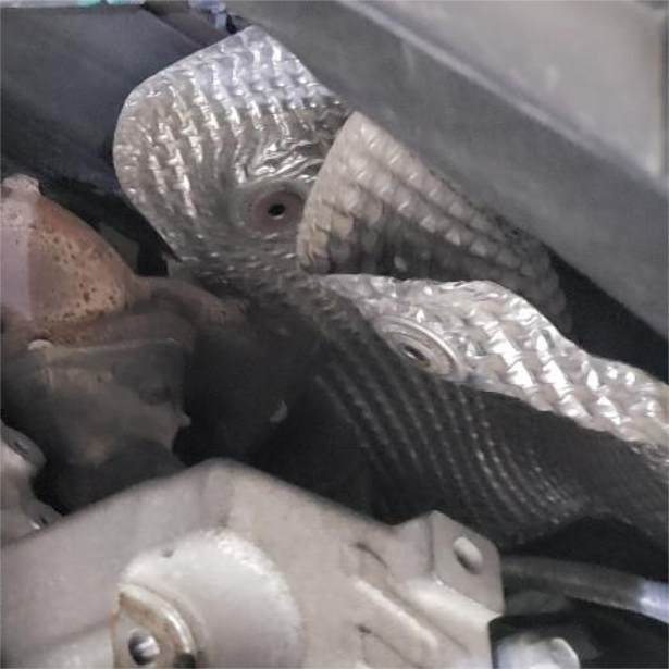 Swing the large rear heat shield out of the way