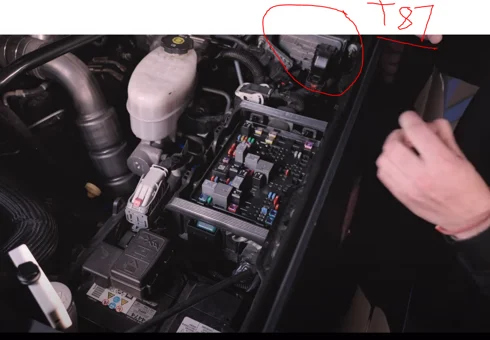 Locate the main fuse panel under the hood, driver side